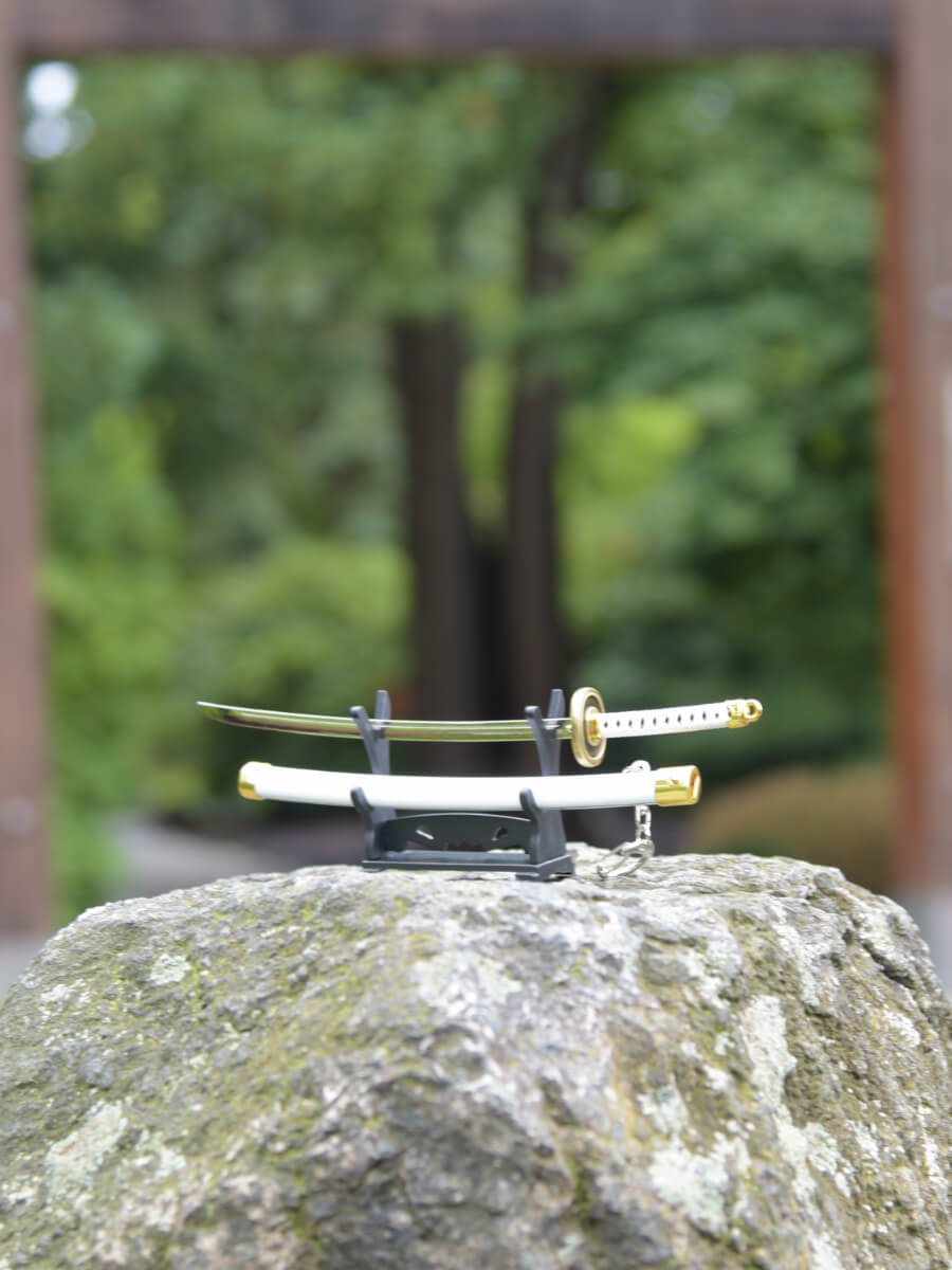Handle side perspective of One Piece's Ichimonji miniature katana on its stand.