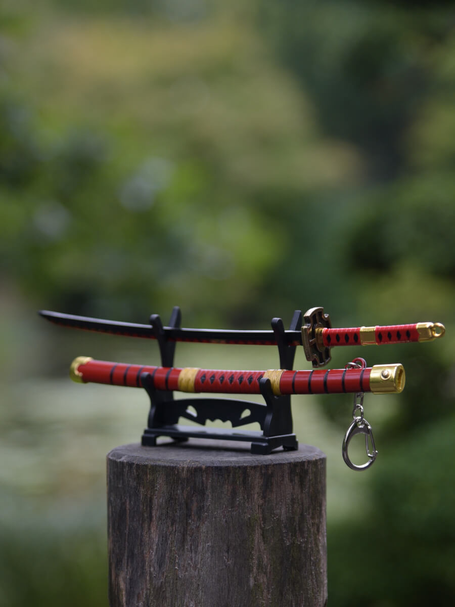 Miniature katana Kitetsu on stand outside, stand on wood, background green trees