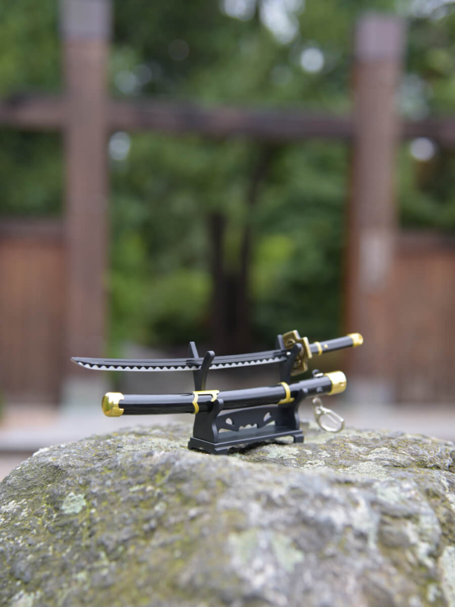 Gentle angled view of Zoro miniature katana blade, emphasizing its sharpness and finesse on the stand.