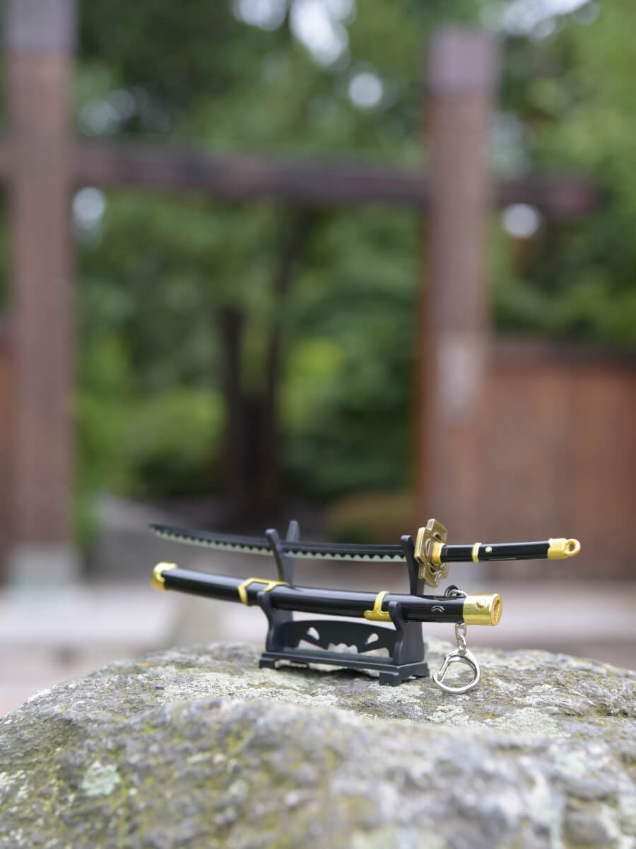 Subtle side view of Zoro miniature katana on its stand, drawing attention to its meticulously designed handle.