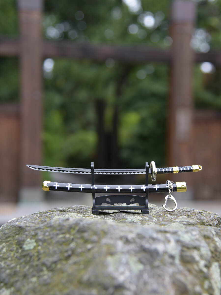 Frontal view of Trafalgar miniature katana from One Piece, elegantly perched on its stand, a testament to its design and historical significance in the series.